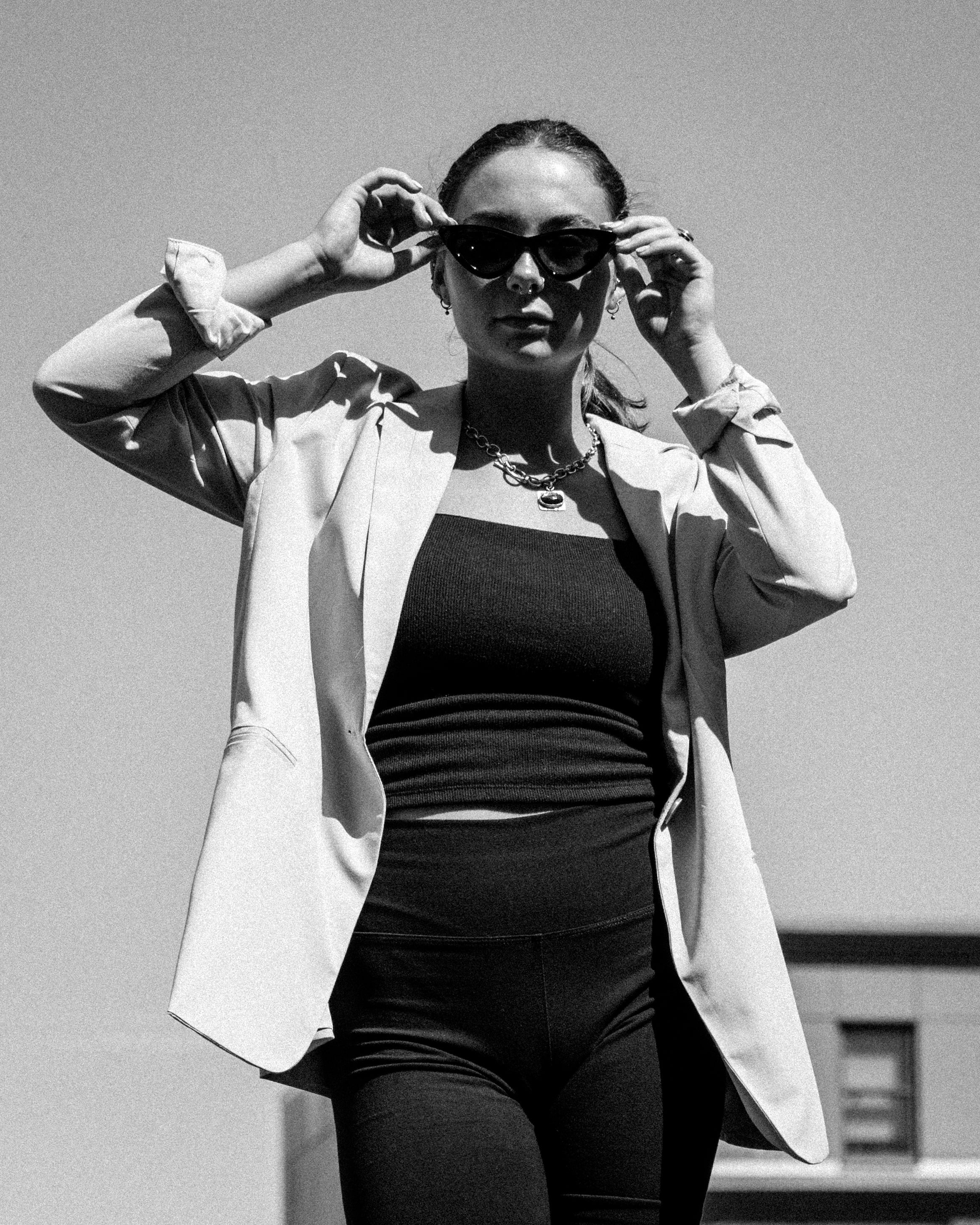Fashion Editorial of girl in blazer holding her sunglasses